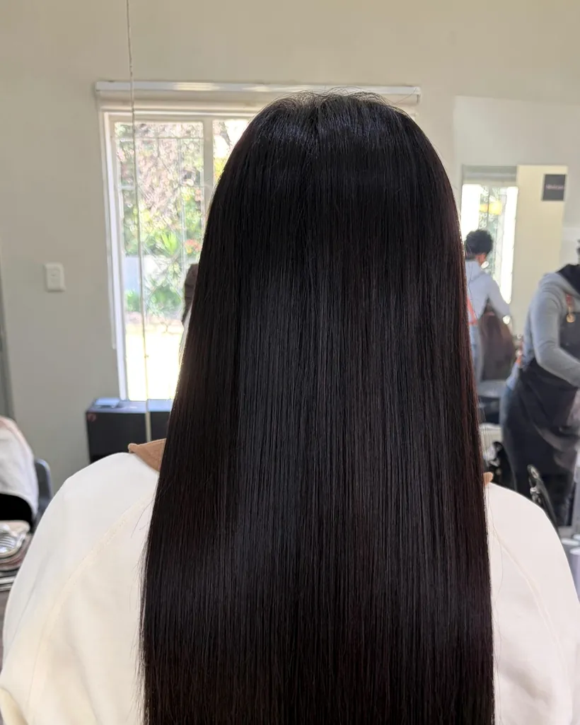 After &mdash; four packs of tape-in hair extensions adding length to dark hair, Johannesburg
